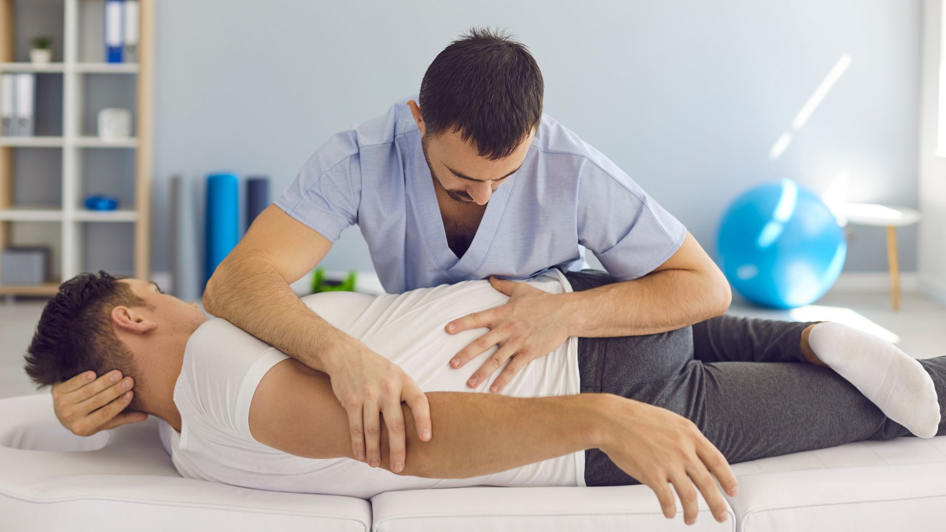 Chiropractor, Osteopath, Physiotherapist or Manual Therapist Working with Male Patient